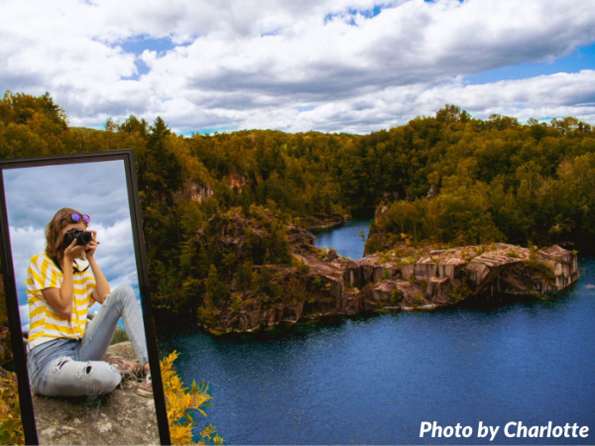 Girl taking picture in mirror overlooking water and coast