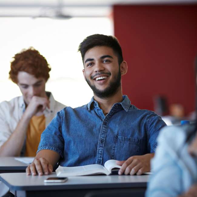 Teen male smiling in a classroom