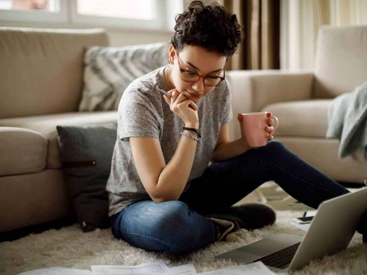 Girl on laptop looking at documents