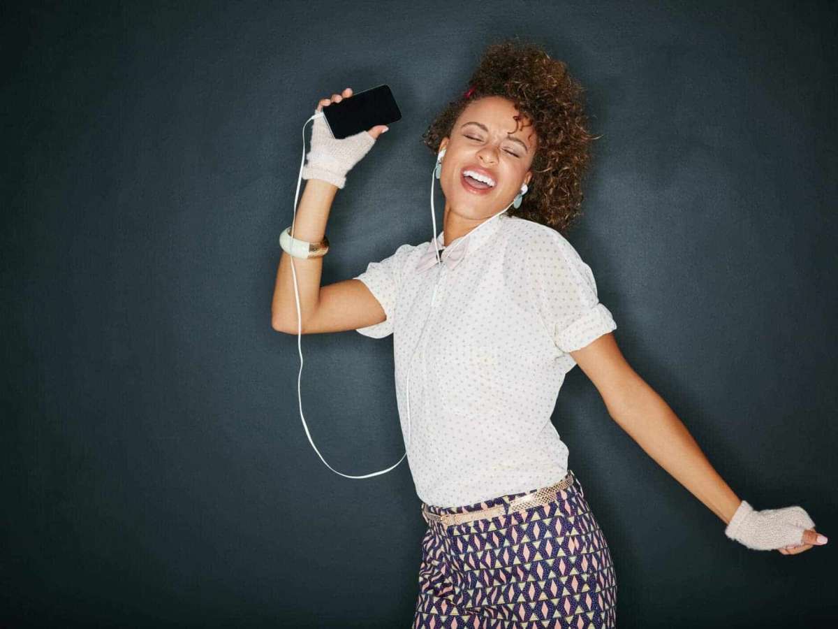 Woman dancing with headphones in.